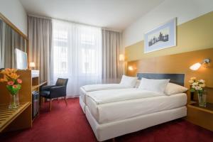 Posteľ alebo postele v izbe v ubytovaní Theatrino Hotel