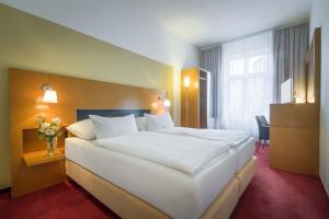 Posteľ alebo postele v izbe v ubytovaní Theatrino Hotel