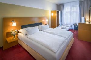 Posteľ alebo postele v izbe v ubytovaní Theatrino Hotel