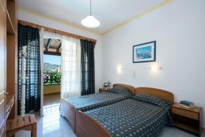 A bed or beds in a room at Andreas Pool Complex