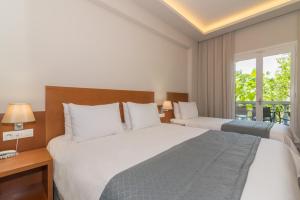 Postel nebo postele na pokoji v ubytování Hotel Palmyra
