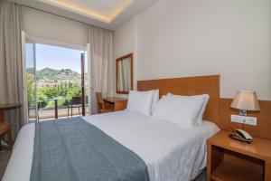 Postel nebo postele na pokoji v ubytování Hotel Palmyra