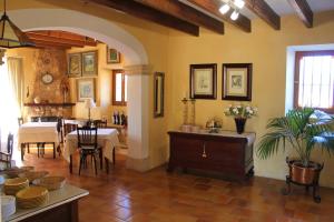 a living room with a table and a dining room at Agroturismo Finca Son Pieras in Llucmajor