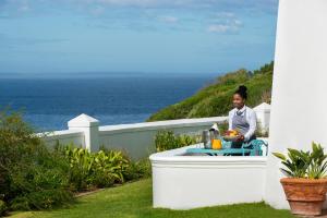 a woman sitting at a table in a bath tub at The Marine Hermanus in Hermanus
