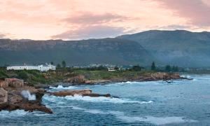 a view of a body of water with mountains at The Marine Hermanus in Hermanus