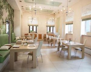 a large dining room with tables and chairs at Medical Hotel & SPA Tyumen in Tyumen