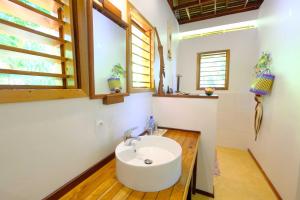 a bathroom with a white sink and a window at Coco Komba Lodge in Nosy Komba +37 photos