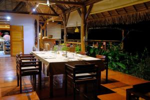 a dining room with a table and some chairs at Coco Komba Lodge in Nosy Komba