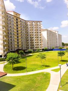 een park met hoge gebouwen en bomen en gras bij SMDC Field Residences - SM Sucat in Manilla