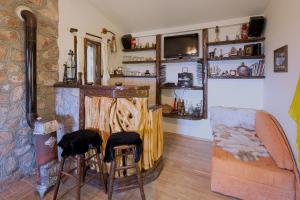 a living room with a stone fireplace and stools at Holiday Home La Musica in Budva