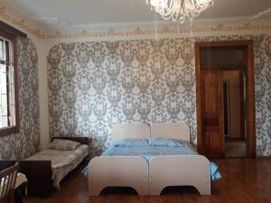 Postel nebo postele na pokoji v ubytování Malkhazi's Guesthouse