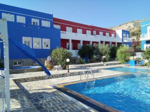 a swimming pool in front of a building at Efstathia Hotel in Xirokambos
