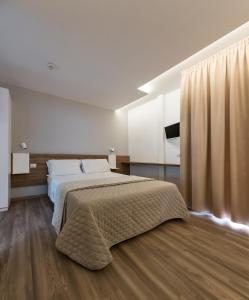 En eller flere senge i et værelse på Riccione Beach Hotel-Vero'Boutique Hotel-