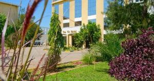 a building with a lot of plants in front of it at The Vic Hotel in Kisumu