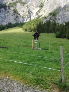 a fence in a field with a bird house at Apart Heim in Fügen