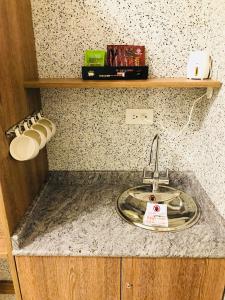 a kitchen counter with a sink and a shelf at Bi Xuelin in Lugu