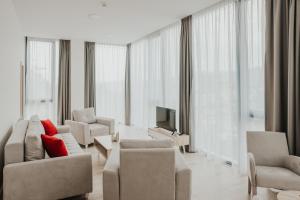 a living room with a couch and chairs and a television at Aparthotel Centar Sarajevo in Sarajevo