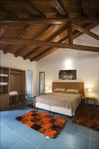 a bedroom with a bed in a room with wooden ceilings at Antico Resort Cerasella in Petralia Soprana