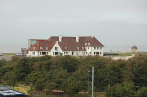 a large white house on top of a hill at Nori TV in Ostend