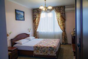 a hotel room with a bed and a window at Respect in Stavropol