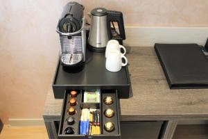 una mesa con cafetera y una cafetera en Dream Hotel Amsterdam en Ámsterdam