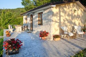 a white building with chairs and flowers in front of it at Casa Rodeli in Motovun