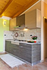 a kitchen with wooden cabinets and a counter top at Casa Rodeli in Motovun