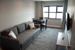 a living room with a couch and a table at The Square Guest Apartment in Stewartstown