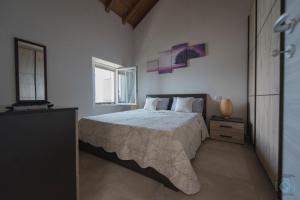a bedroom with a large bed and a window at Home Sweet Home Lakeview in Oggebbio