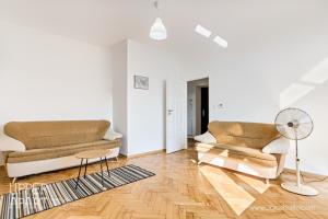 a living room with two chairs and a table at Upper Apart in Cieszyn