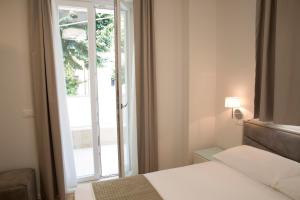 a bedroom with a bed and an open door at Boutique Hotel Enia in Prato +50 photos