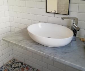 a white bath tub sitting on a counter in a bathroom at The Grand Meshmosh Hotel in Beirut