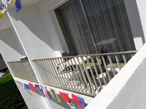 a balcony of a house with flags on it at Hôtel Ker-Noyal Quiberon Plage in Quiberon