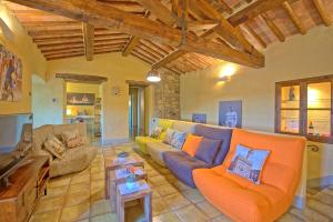 a large living room with couches and a table at Villa Sonia by PosarelliVillas in San Donato in Poggio
