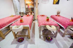 duas mesas num quarto com toalha de mesa rosa em The Syron Huts Lembongan em Nusa Lembongan