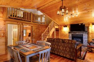 a living room with a table and a couch and a fireplace at Cobble Mountain Lodge in Lake Placid