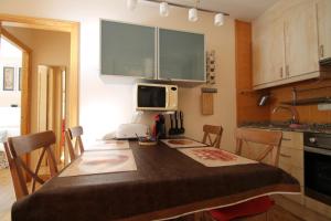 a small kitchen with a table and a microwave at Julia, el Tarter, zona Grandvalira in El Tarter