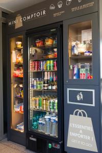 a vending machine in a store with food and drinks at Kyriad Montpellier Sud - Lattes in Montpellier