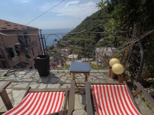 2 sillas y una mesa con vistas al océano en Cinqueterre Holidays, en Riomaggiore