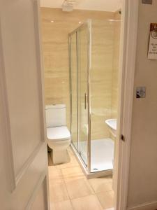 
a bathroom with a toilet, sink, and shower at The Paramount Hotel in London
