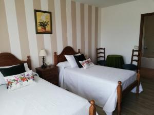 מיטה או מיטות בחדר ב-A Casa De Amparo