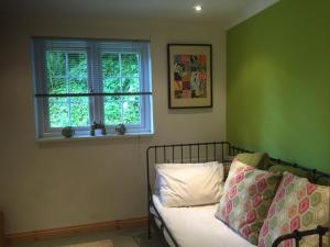 a bedroom with a bed and a window at Scaurbridge Cottage with Hot Tub and Sauna in Thornhill