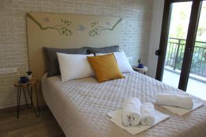 a bedroom with a bed with towels on it at House Ekton in Pefkari