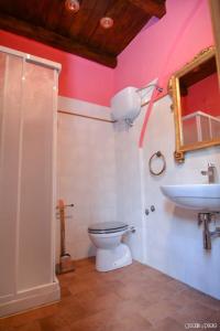 a bathroom with a toilet and a sink at Torre Caetani- Night in a medieval tower in Todi