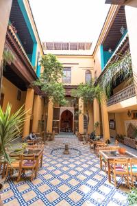a courtyard with tables and chairs in a building at Medina social club in Fès