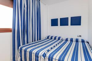 
A bed or beds in a room at Apartamentos Tossa Dreams
