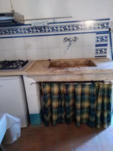 a kitchen with a sink and a stove at Agriturismo Stigliano in Sarteano