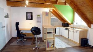 a small office with a desk and a chair in a room at Haus Fliegerhorst in Königschaffhausen