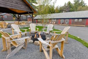a group of chairs sitting around a fire pit at Cobble Mountain Lodge in Lake Placid +145 photos