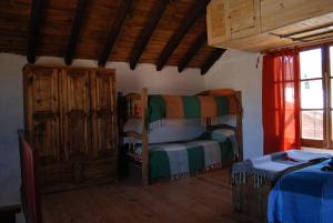a bedroom with a bunk bed and a crib at Cabañas Wenelcklén in Uspallata